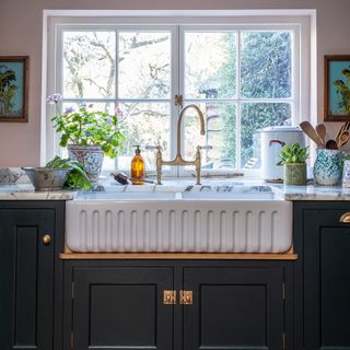fluted side kitchen belfast sink in front of a window