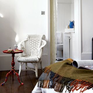 guest bedroom with white walls and wooden flooring