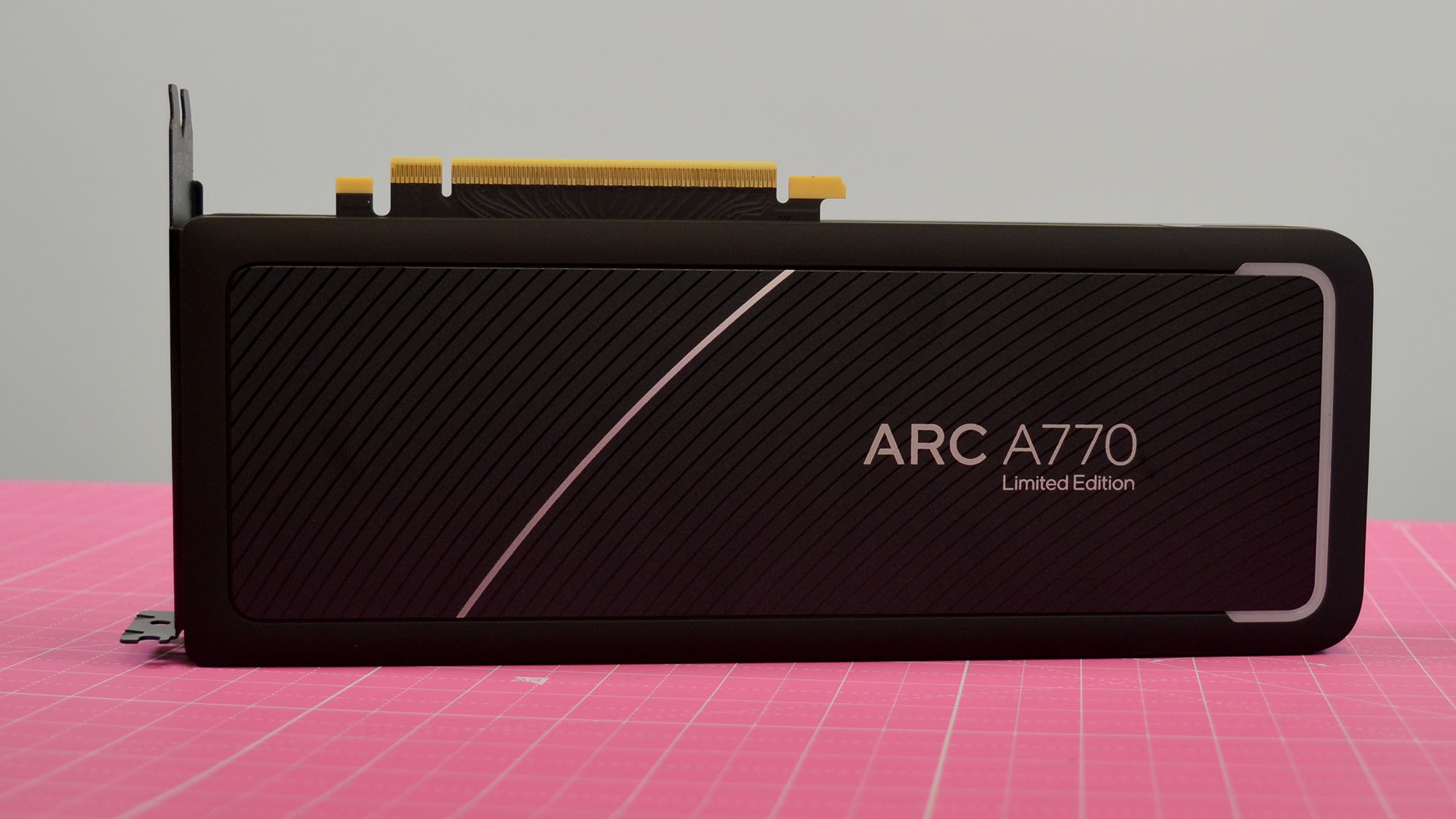 An Intel Arc A770 LE graphics card on a table with a pink desk mat