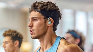 Man wearing Anker Soundcore Sport X20 during a workout.