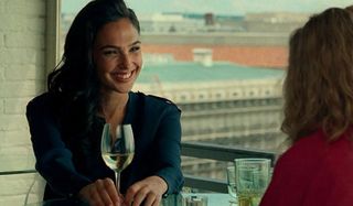 Wonder Woman drinking some wine and having lunch.