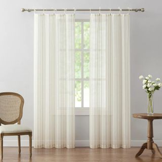 Sheer white curtains on a living room window