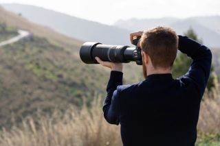 Photographer using the Canon RF 800mm F11 in the countryside