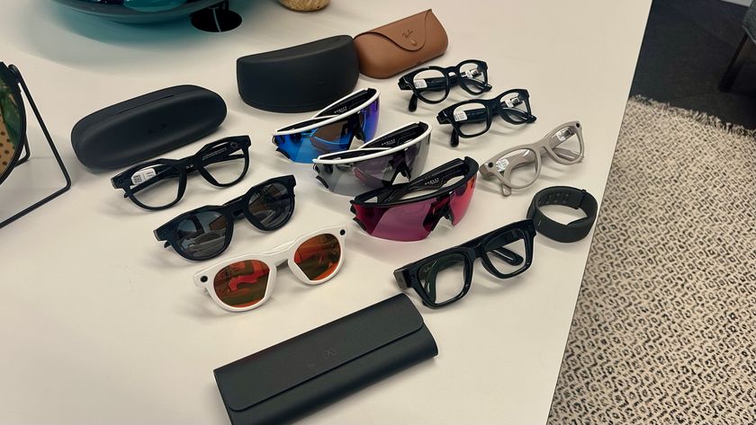 Three Oakley Meta HSTN, three Oakley Meta Vanguard, and three Ray-Ban Meta (Gen 2), along with cases, sitting atop a table in various styles, along with the Meta Ray-Ban Display glasses in front of them all.