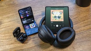 Spotify on the Z Flip 3 and Z Fold 3 with headphones and earbuds next to them