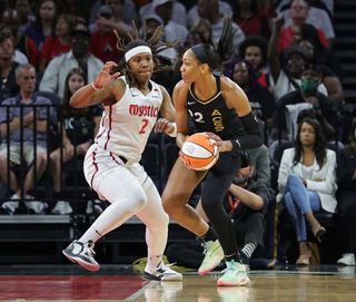  A'ja Wilson #22 of the Las Vegas Aces is guarded by Myisha Hines-Allen #2 of the Washington Mystics in the first quarter of their game at Michelob ULTRA Arena on August 11, 2023 in Las Vegas, Nevada. The Aces defeated the Mystics 113-89.