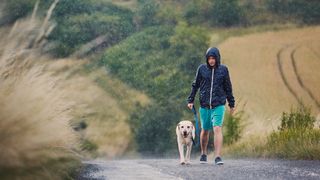 Man walking dog in rain