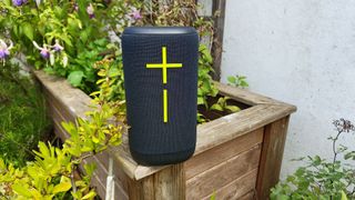 Ultimate Ears Everboom wireless speaker stood upright on wooden planter