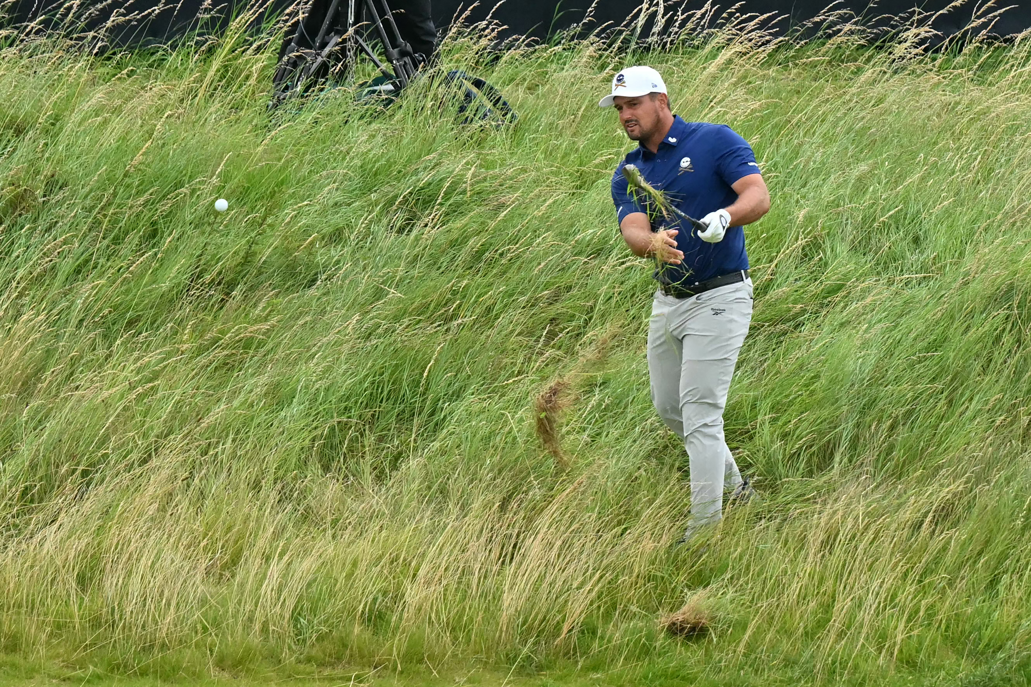 Bryson DeChambeau hits a shot out of thick rough