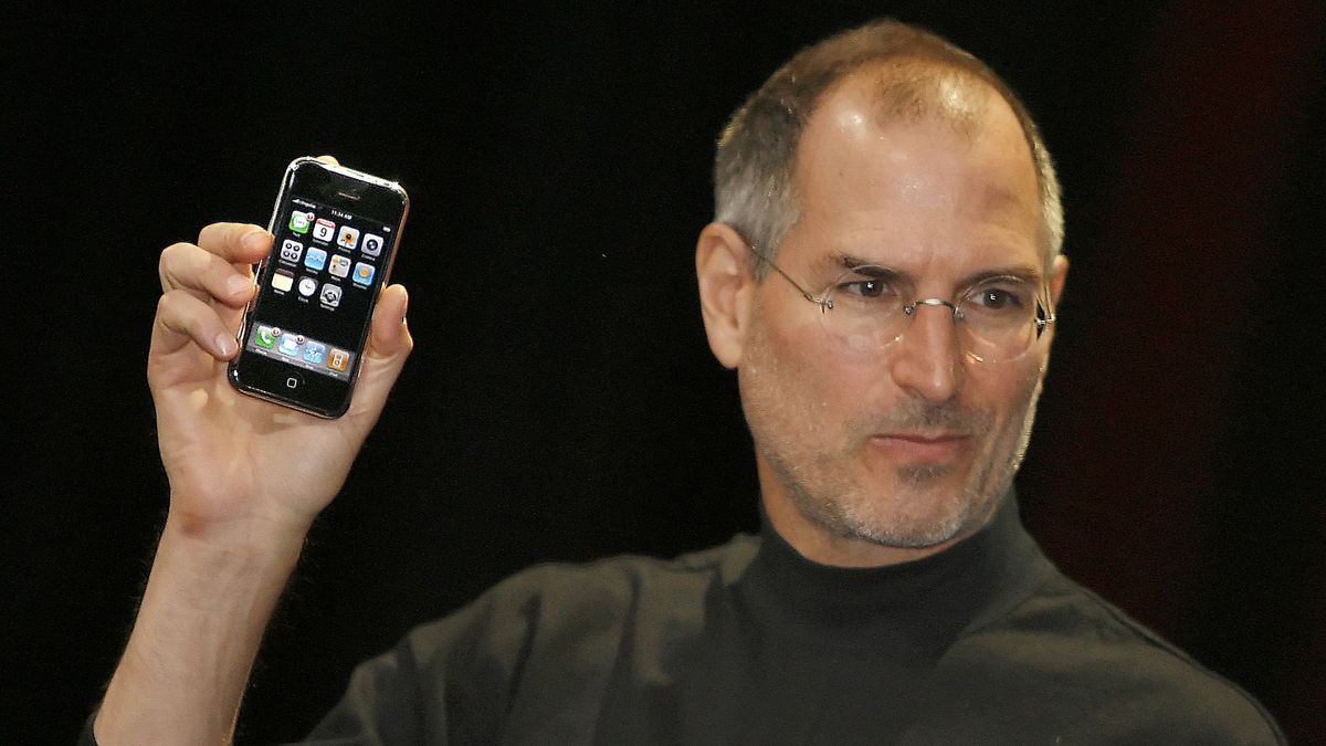 Steve Jobs holds up an original iPhone at 2007 Macworld Expo