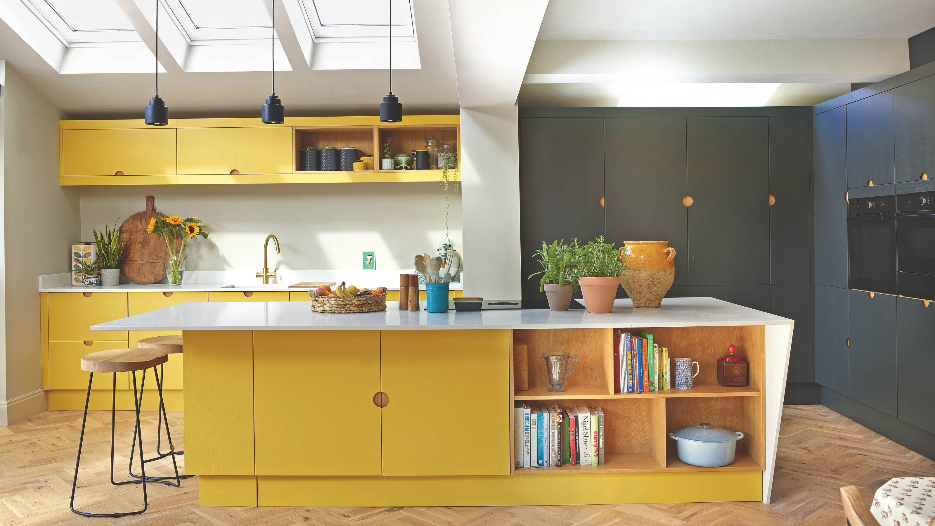 Butter yellow and navy kitchen.