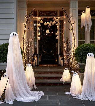 halloween porch and steps decor with light up ghosts, garlands, and decorative faux trees