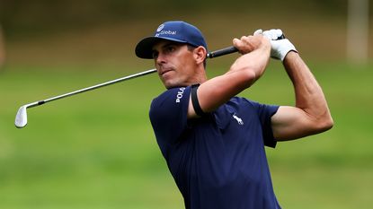 Billy Horschel picks up golf ball with putter in a never-before