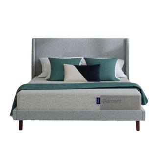 A gray bed with a gray mattress with white and teal pillows and a teal bed runner on it