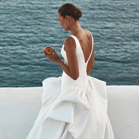 a model wearing a v-neck wedding gown.