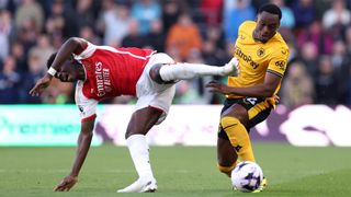 Arsenal's Bukayo Saka and Wolves' Toti Gomes challenge for the ball during the sides' April 2024 encounter at Molineux ahead of the Arsenal vs Wolves live stream