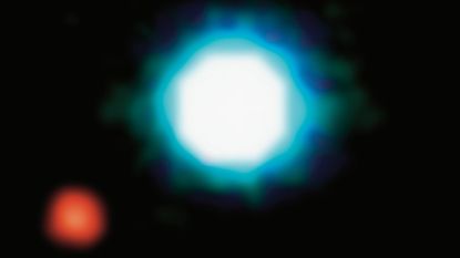 A black background with a large blue glowing orb in the middle and a smaller red orb to the bottom left