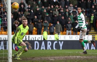 Christopher Jullien watches on as Ryan Christie's free-kick finds the net