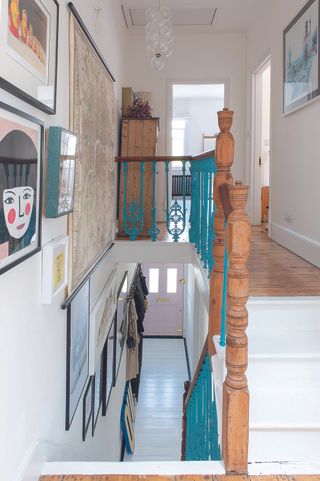 painted staircase with gallery wall