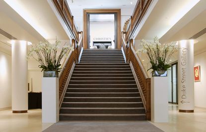 Looking up a grand wooden staircase