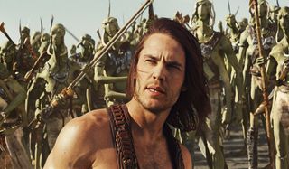 John Carter stands in front of a bunch of Tharks