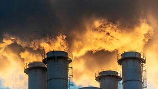 An image of smoke and exhaust from smokestacks of an industrial facility