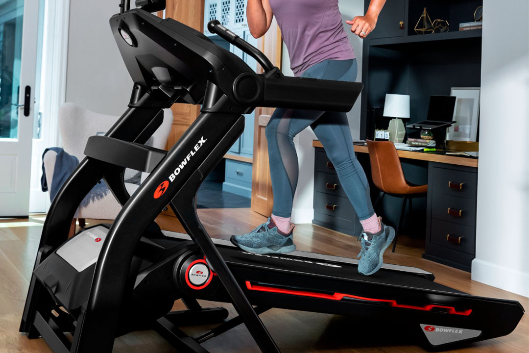 a woman using a Bowflex 10 treadmill