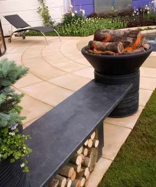 modern garden bench with integrated log store and fire pit