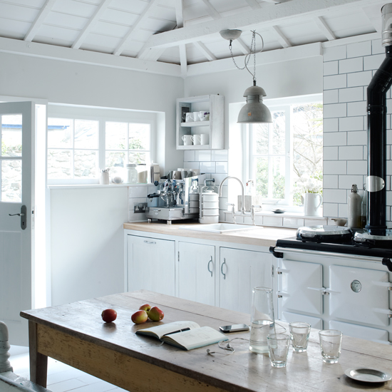 kitchen with white walls white cabinet and wooden worktop