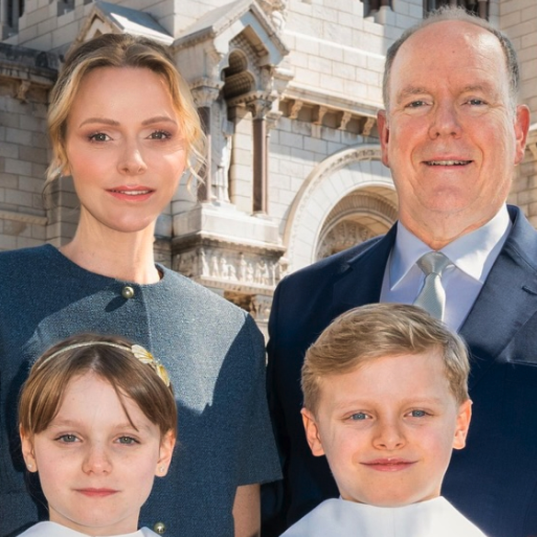 Princess Charlene and Prince Albert of Monaco pose with their twins, Jacques and Gabriella, who are wearing matching white gowns to take their First Communion