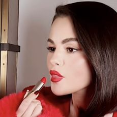 Selena Gomez putting on lipstick in an Instagram reel