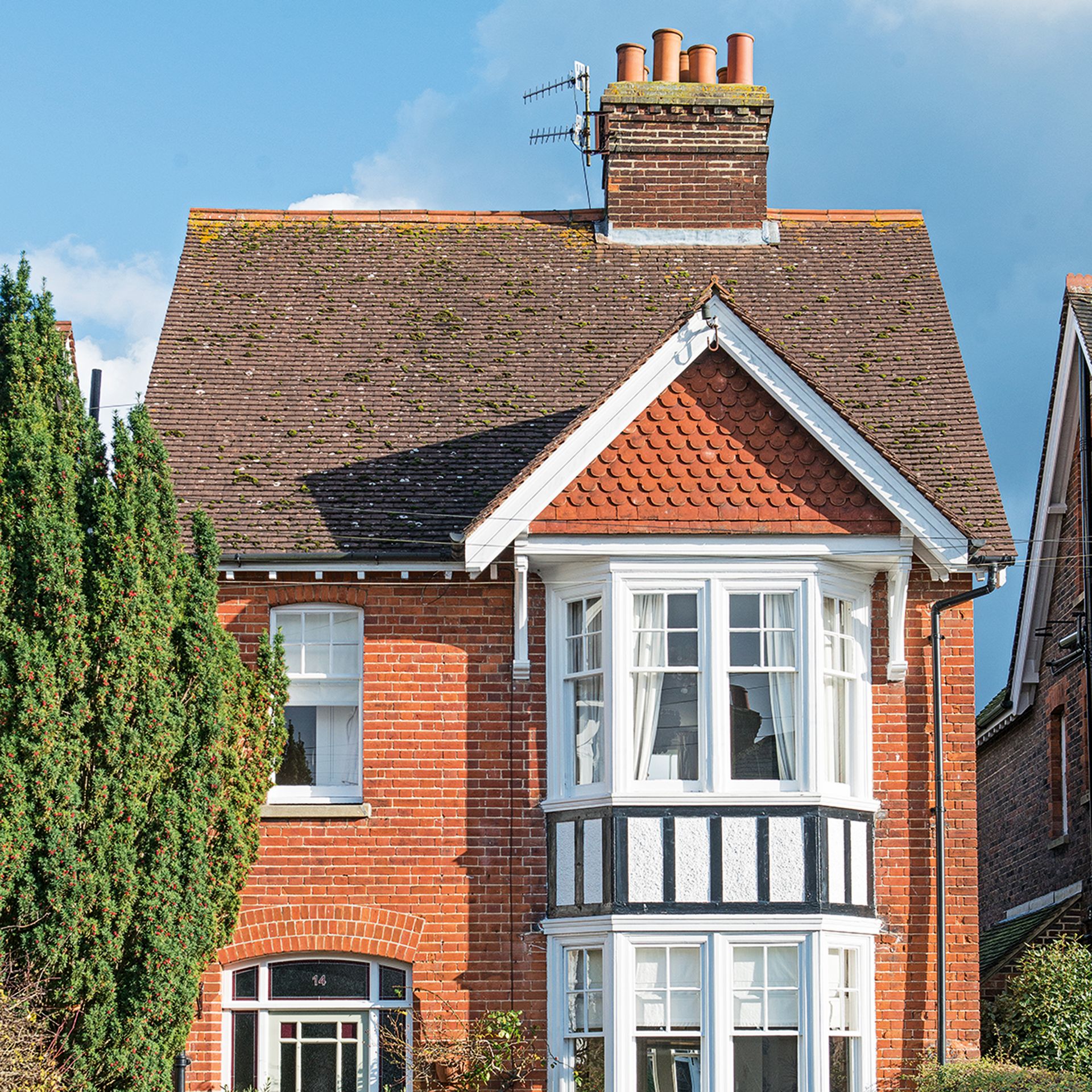 Exterior of a red brick detached house with tiled roof