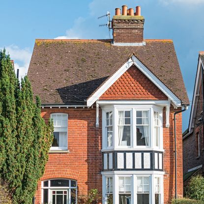Exterior of a red brick detached house with tiled roof