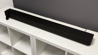 Sony Bravia Theatre Bar 8 soundbar on white storage unit in front of TV viewed from above