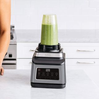 Ninja 3-in-1 Food Processor showing green smoother in blender attachment