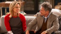 T&eacute;a Leoni as Jeanie and Tim Daly as James sitting on a couch together on NBC's Newlyweds.