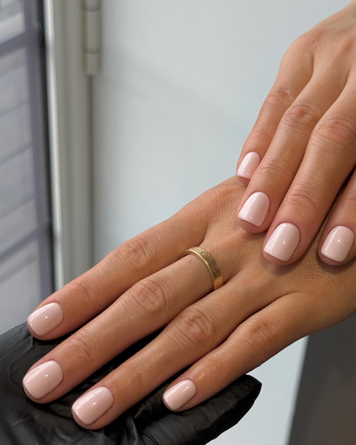 A close-up shot of a creamy neutral manicure
