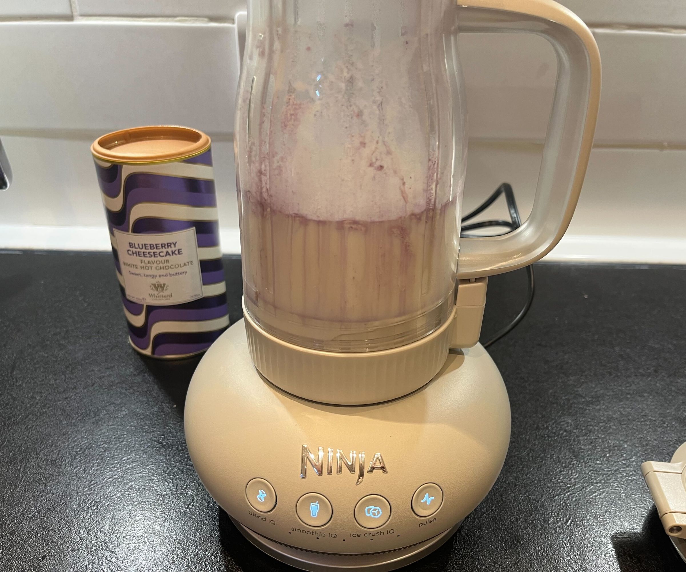 Pre-blending a blueberry milkshake in a tumbler style blender. 