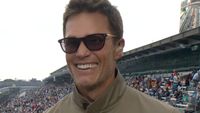 Tom Brady smiling while talking at the Indy 500
