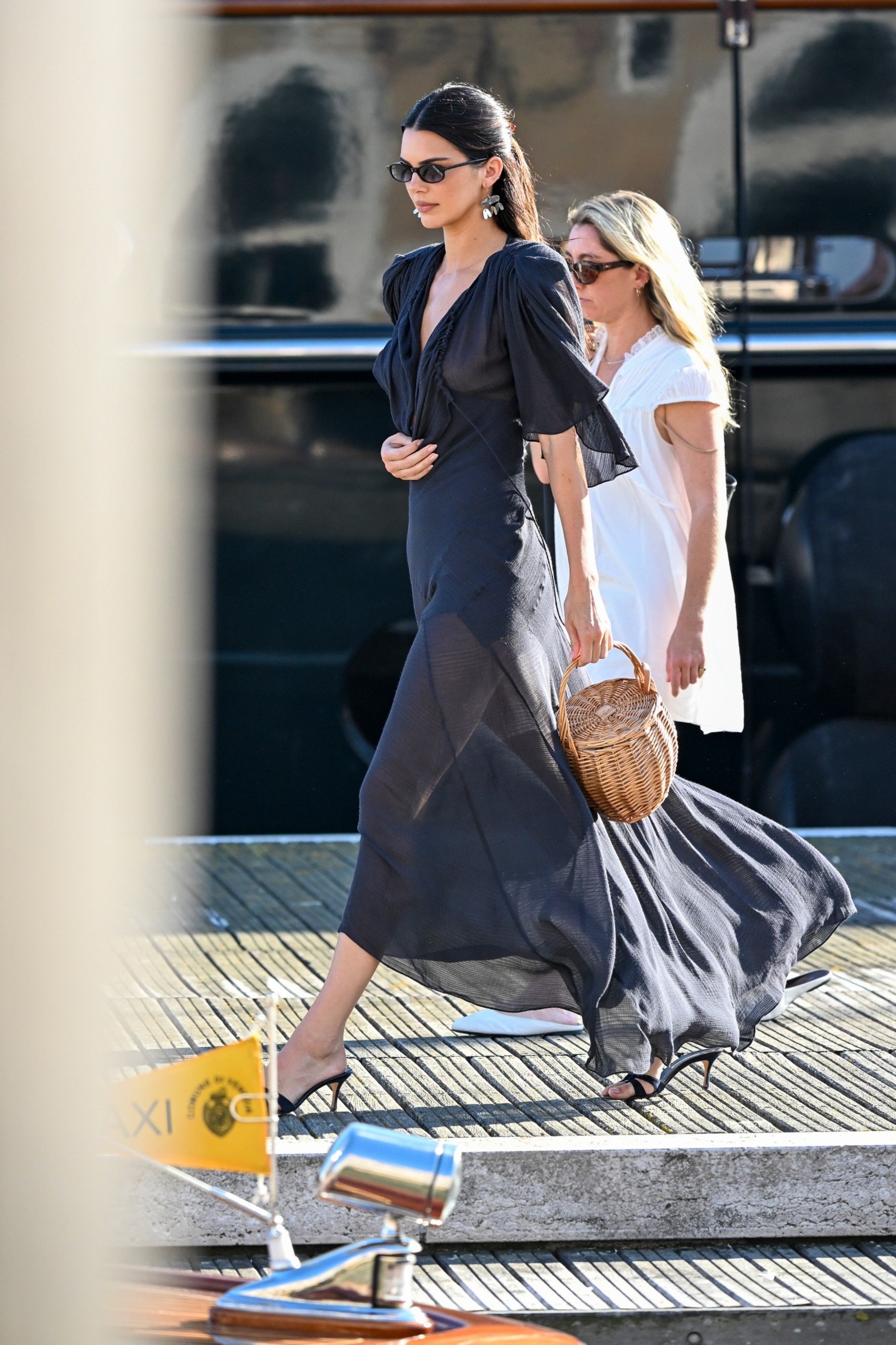 Kendall Jenner styled a semi-sheer little black dress with the basket bag trend at the Venice Film Festival