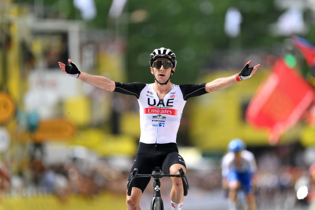 Adam Yates (UAE Team Emirates) celebrates as stage 1 winner ahead of his brother Simon Yates (Jayco-AlUla)