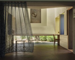 curtain blowing in the wind inside workspace and studio of sonoma house mourning dovecote