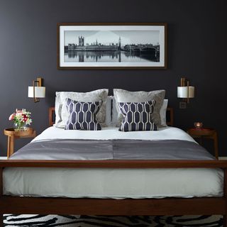 boutique style bedroom with hotel style lighting with grey wall