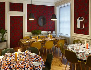 Dining area where each table has its own set of matching tablecloth and napkins in geometric designs
