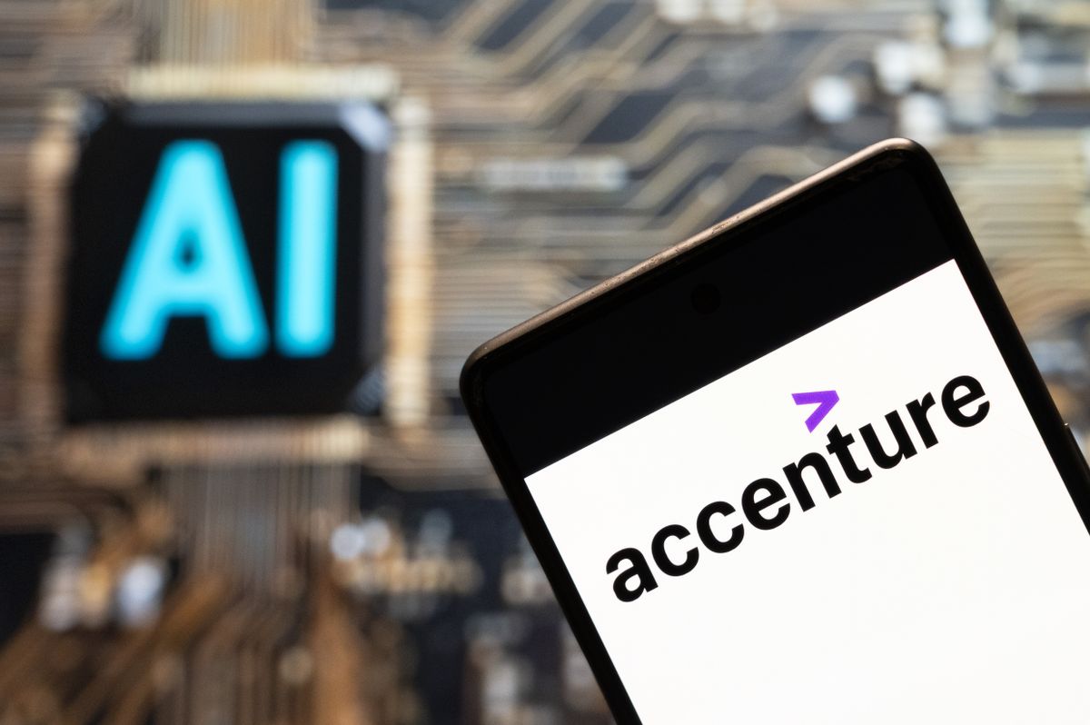 Accenture logo pictured on a smartphone with &#039;ai&#039; written in background