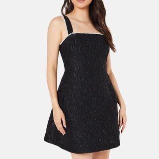 flat lay image of a black dress