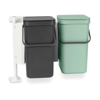 Black and green bins attached to a cupboard