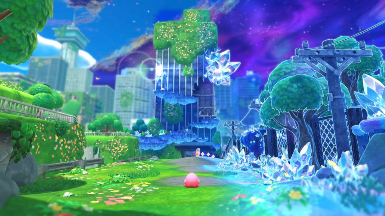Kirby and the Forgotten Land Star-Crossed World screenshot showing Kirby in a city-scape stage, with one half of it covered in crystal