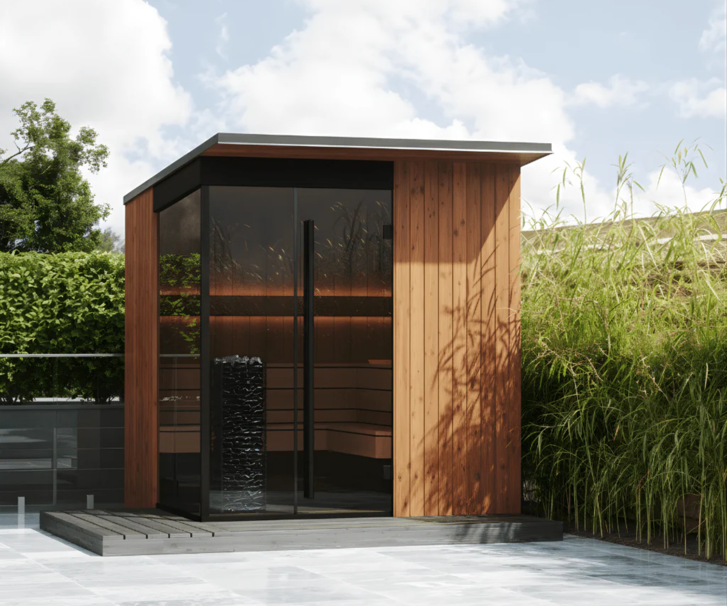sauna cabin with wood exterior, smoked glass doors on raised platform of patio with bamboo planting to one side