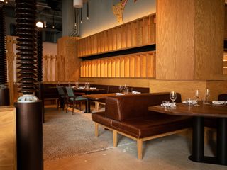 Interior of Hav & Mar restaurant New York with tables, benches and wooden shelving